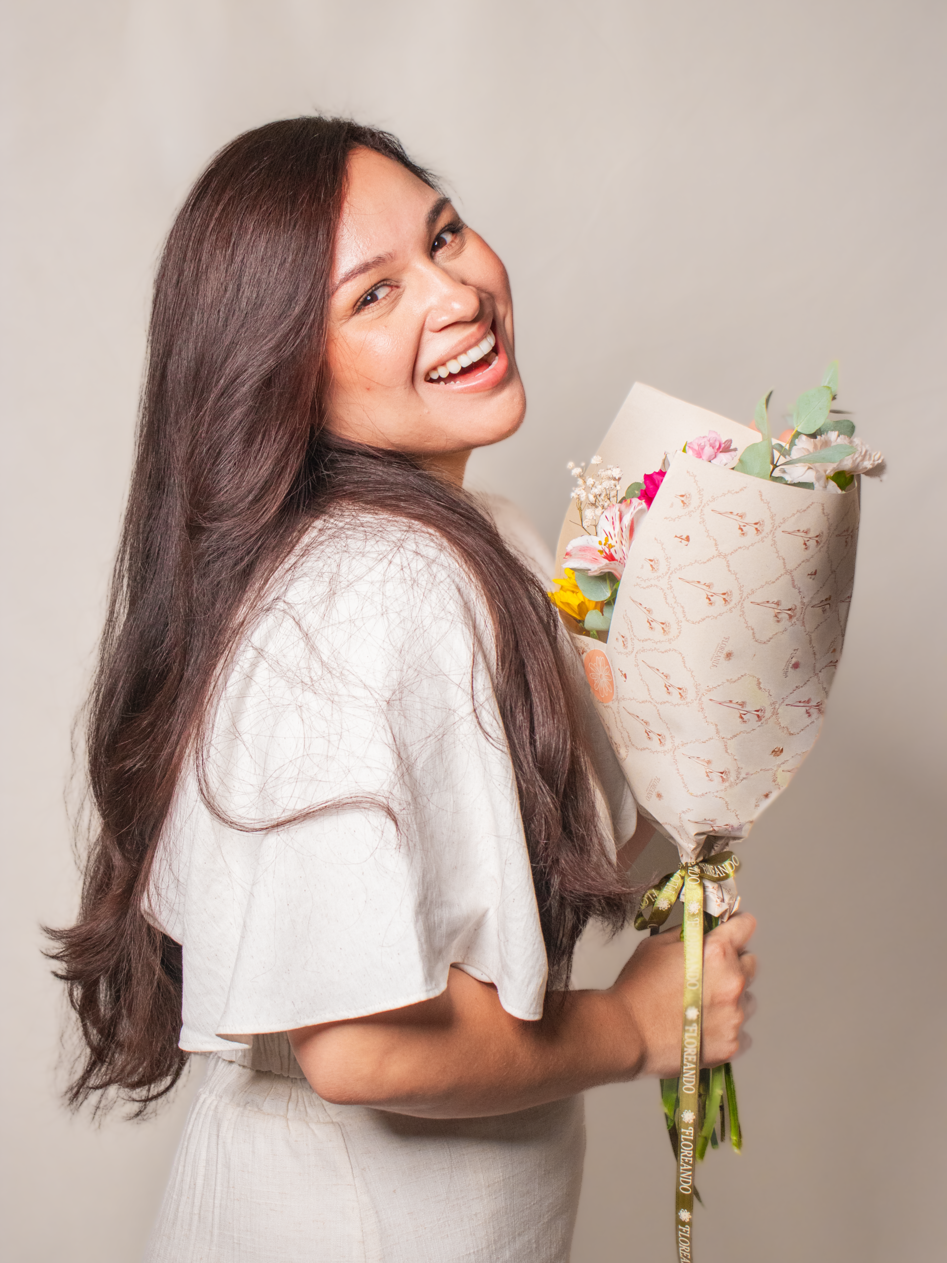 Mujer sonriendo con flores de Floreando Concept store